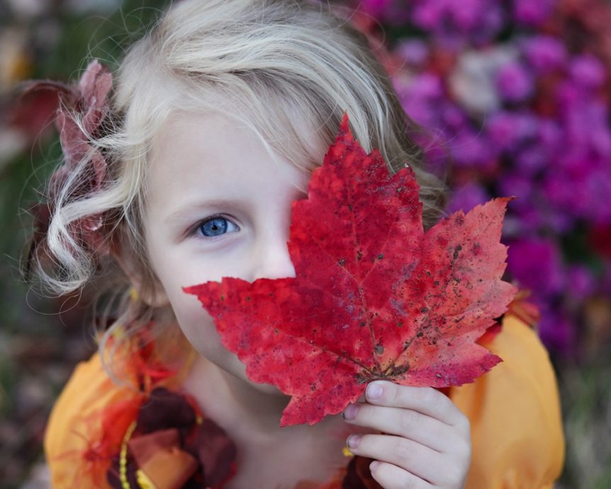 Girl holding maple leaf